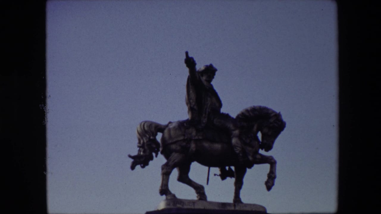 The same Brussels equestrian statue appears against a clearer blue sky, with the rider and horse silhouetted by the 8mm exposure.