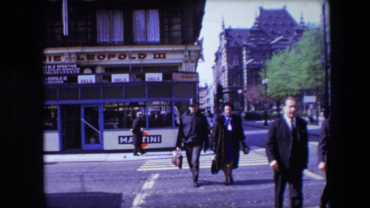 A 1967 Calais street view shows pedestrians crossing at a zebra crossing, with a suited man near the right edge and commercial signs in the background.