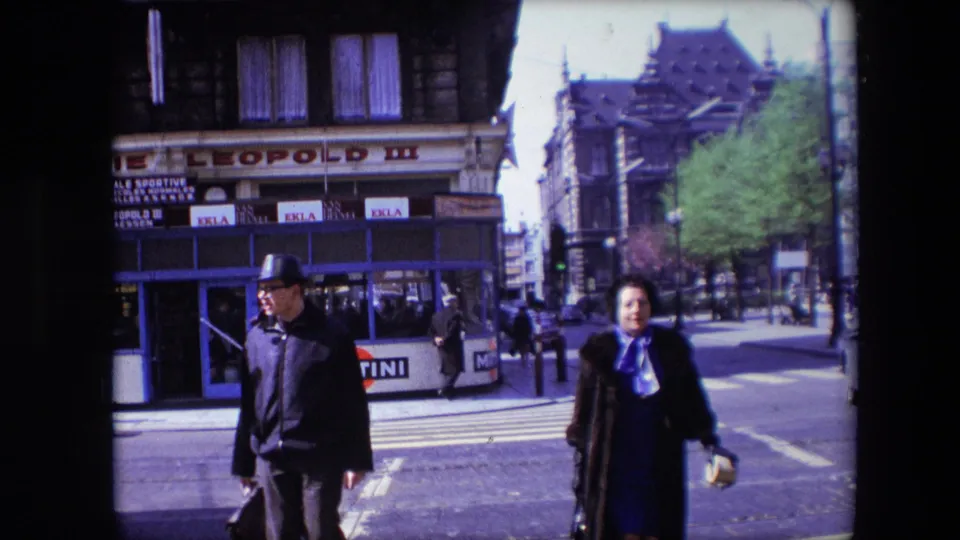 The final frame shows the Calais crosswalk as a man in a hat and a woman in a coat move through the foreground, with storefront signage and street advertising still visible.