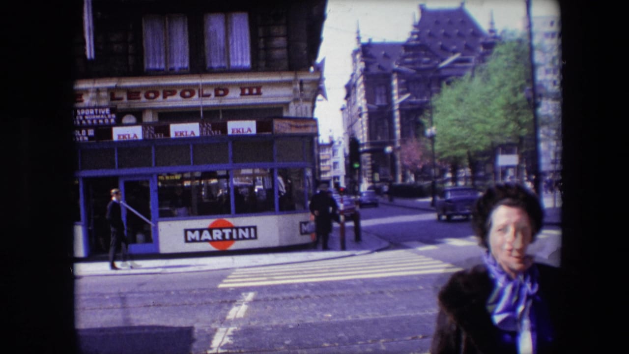 Brasserie corner with Martini sign, pedestrians, cars, and woman partly entering foreground.