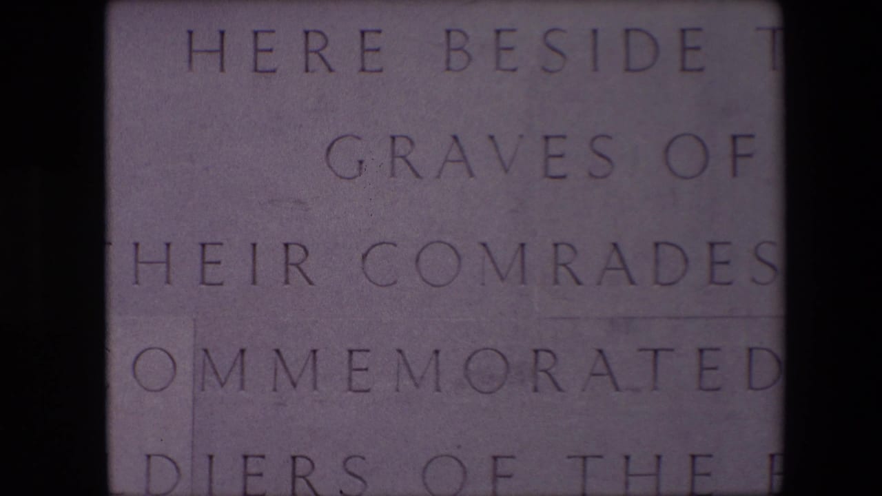 Close 1967 Calais frame of an English-language memorial inscription, with carved lines including graves, comrades, and commemorated soldiers visible on stone.