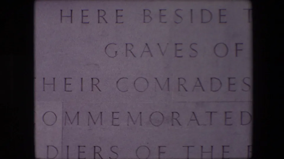 Close 1967 Calais frame of an English-language memorial inscription, with carved lines including graves, comrades, and commemorated soldiers visible on stone.