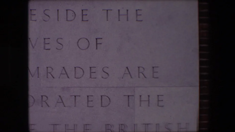 Final 1967 Calais frame holds on the memorial inscription, with cropped carved text and part of the word British visible near the bottom edge.