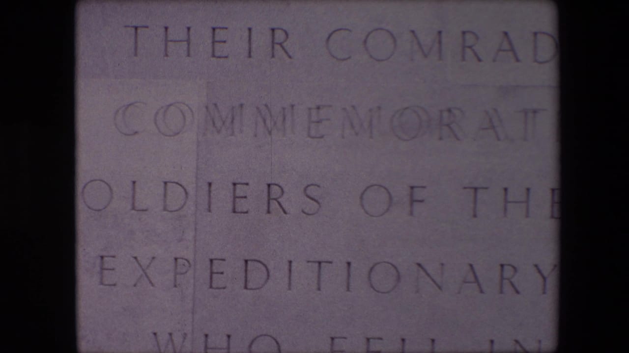Engraved words on a stone memorial plaque divided by a dark vertical strip.
