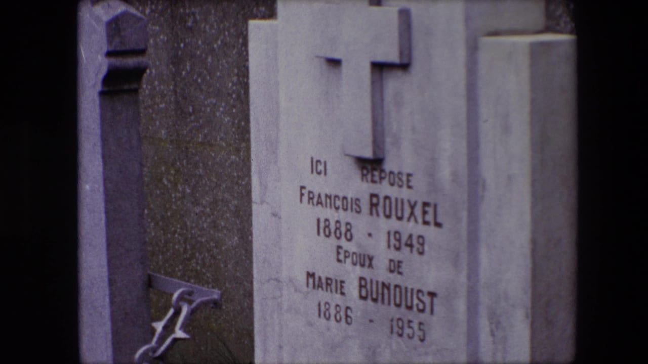 1967 Calais 8mm frame showing a cemetery gravestone with a raised cross and engraved names for François Rouxel and Marie Bunoust.