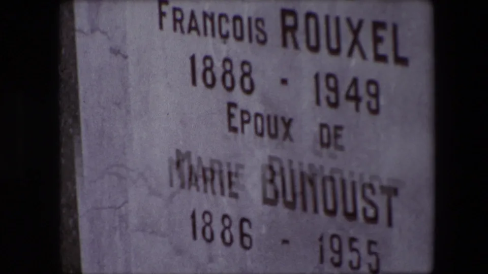 Close-up from the 1967 Calais home movie showing a weathered headstone inscribed for François Rouxel and Marie Bunoust with birth and death dates.