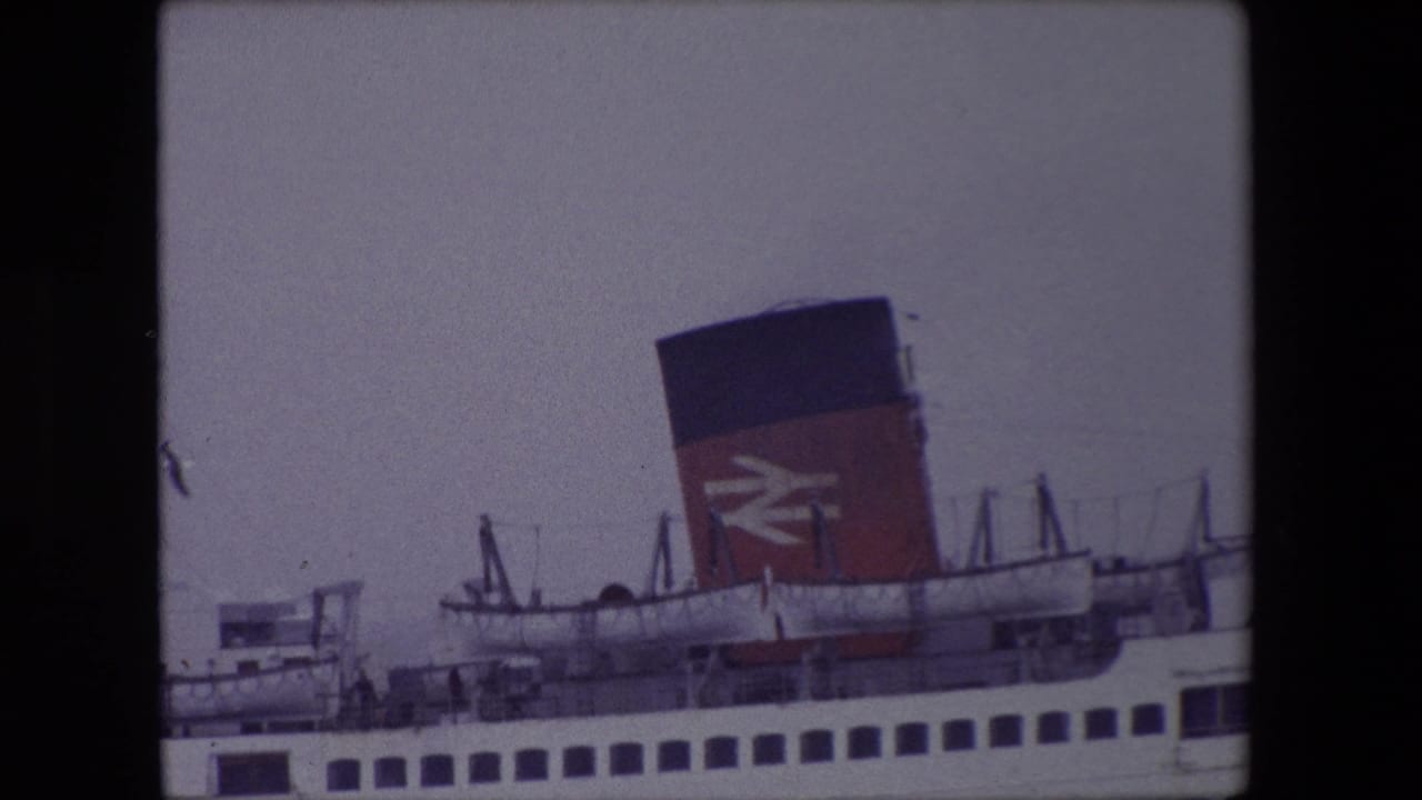 Ferry funnel with British Rail logo, deck structures, and a gull crossing the sky.