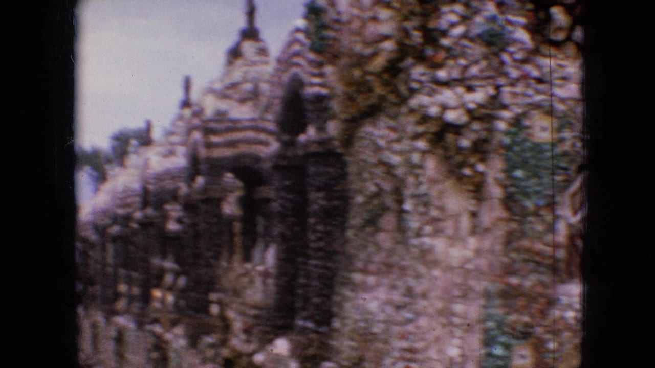 Close view of pebble-covered towers and a rough stone wall.