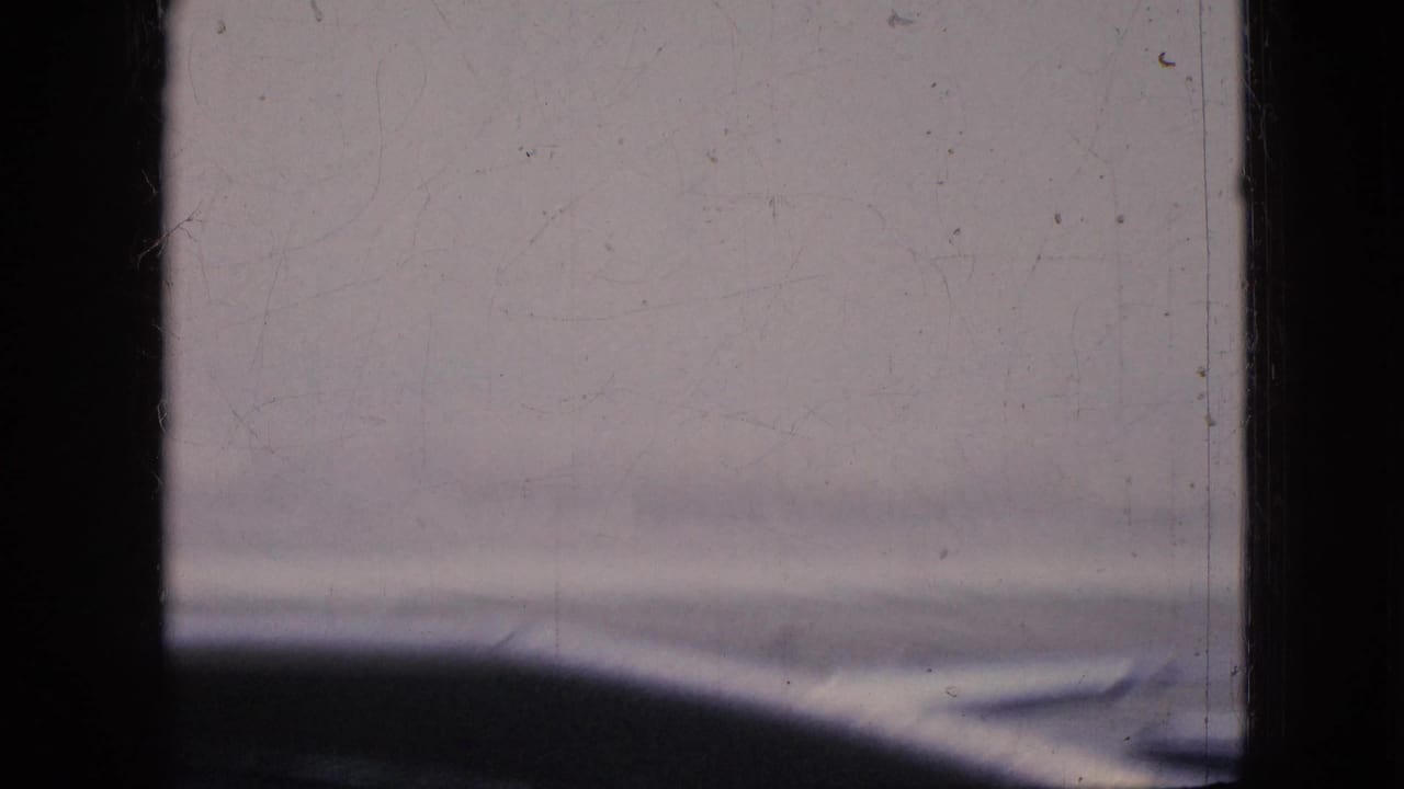 Blurred view through a vehicle window with dark interior framing.