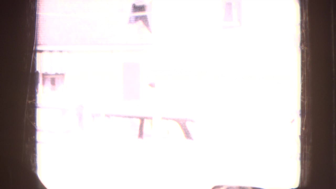 Bright overexposed exterior view with parts of a building barely visible.
