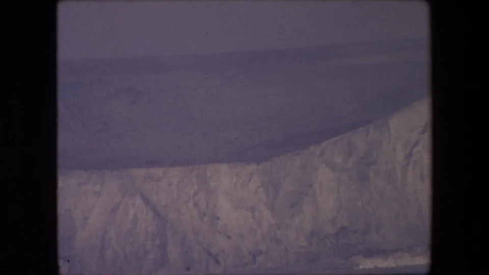 1967 8mm home-movie frame with the lower chalk cliff and sea visible, cropped by the contact sheet and rendered in muted archival color.