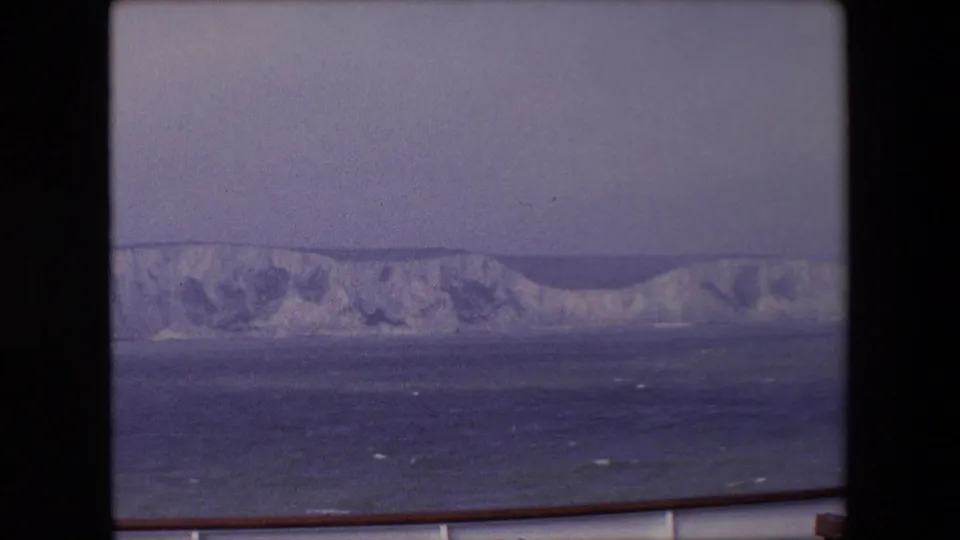 Final frame in the contact sheet shows distant pale cliffs under a muted sky, seen from a boat with railing visible at the bottom.