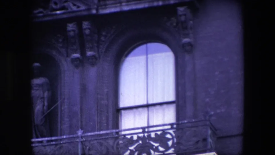Closer 1967 London view of the church facade, with the curtained arched window centered near carved trim and a partially shadowed statue niche.