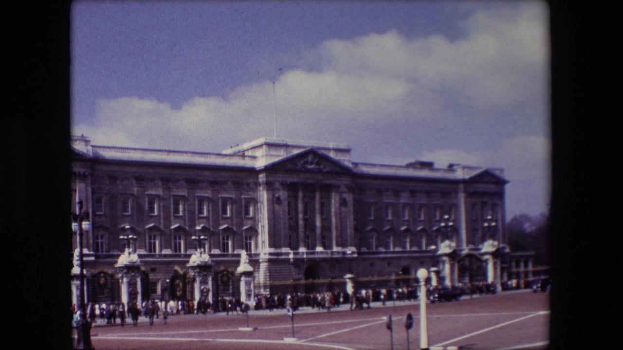 Static view of Buckingham Palace with visitors along the forecourt.