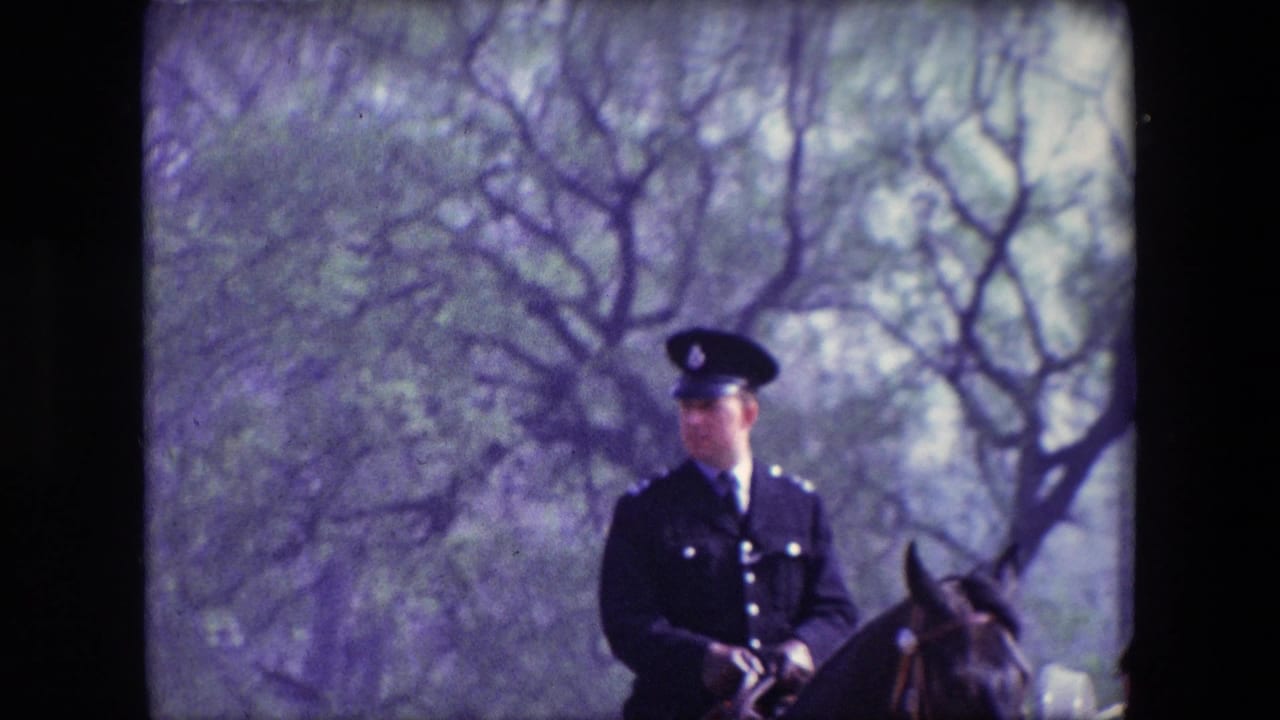 A mounted uniformed officer appears on horseback in a park-like London setting, with bare trees and soft 8mm color from the supplied 1967 footage.