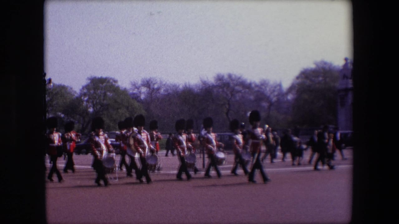 Uniformed musicians continue marching past with drums and brass instruments.