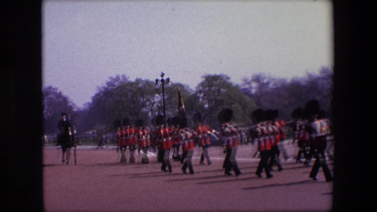 A marching guard formation crosses the roadway with a mounted figure visible behind them.
