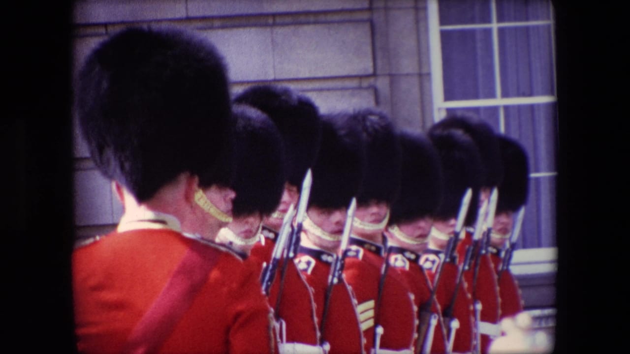 A line of red-coated guards with black caps and bayoneted rifles fills the frame.