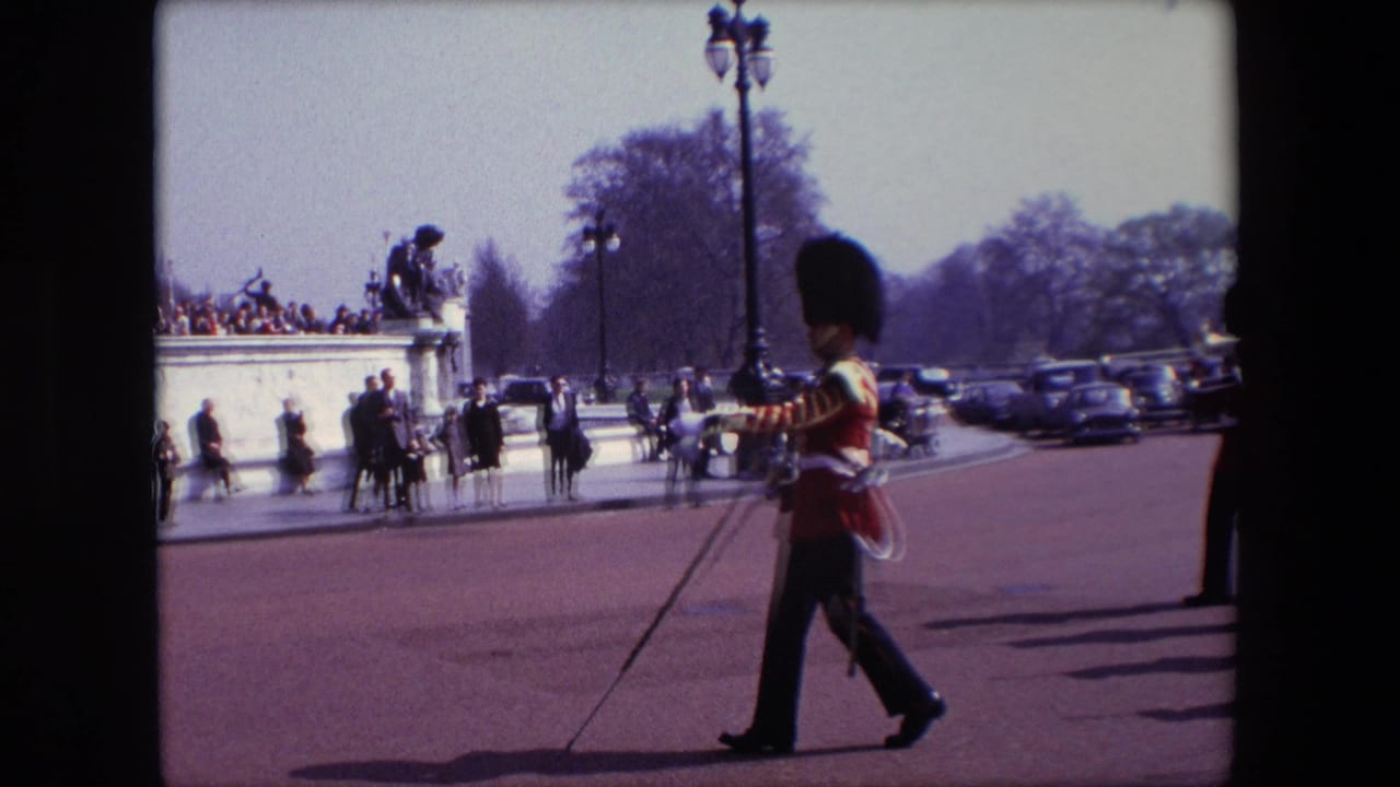 Guard in ceremonial uniform marches past spectators near the Victoria Memorial.