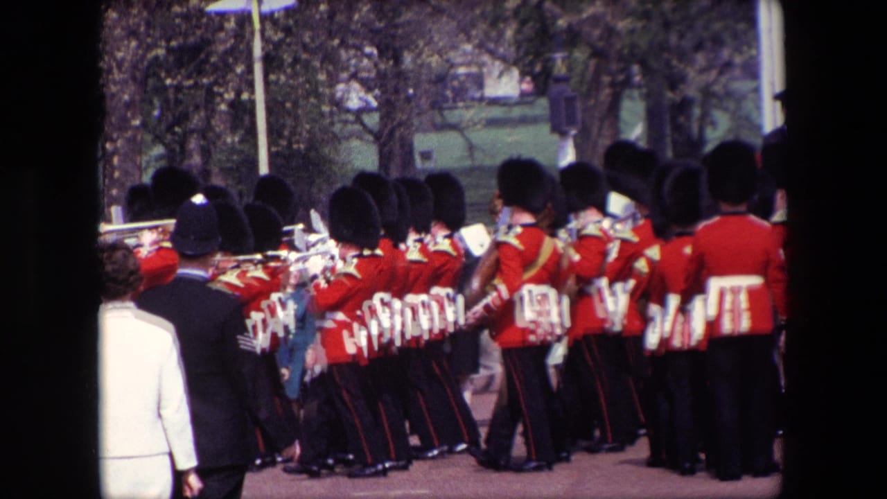 Band members in red jackets play brass instruments near spectators.
