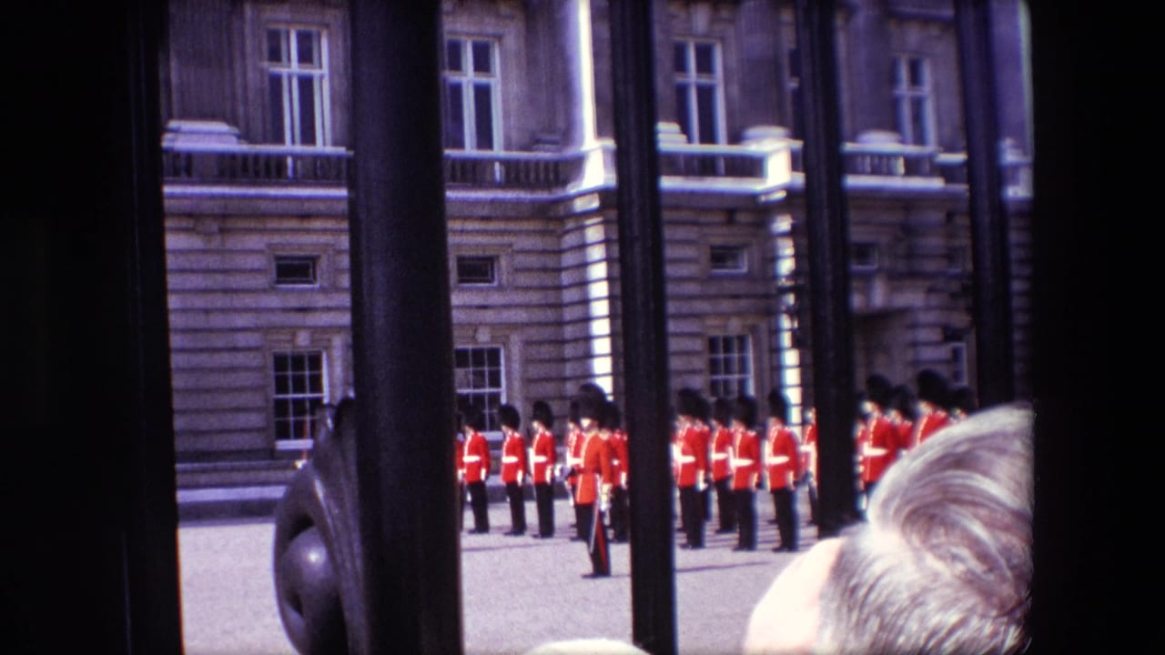 Rows of guards stand beyond the gate while spectators' heads appear in the foreground.