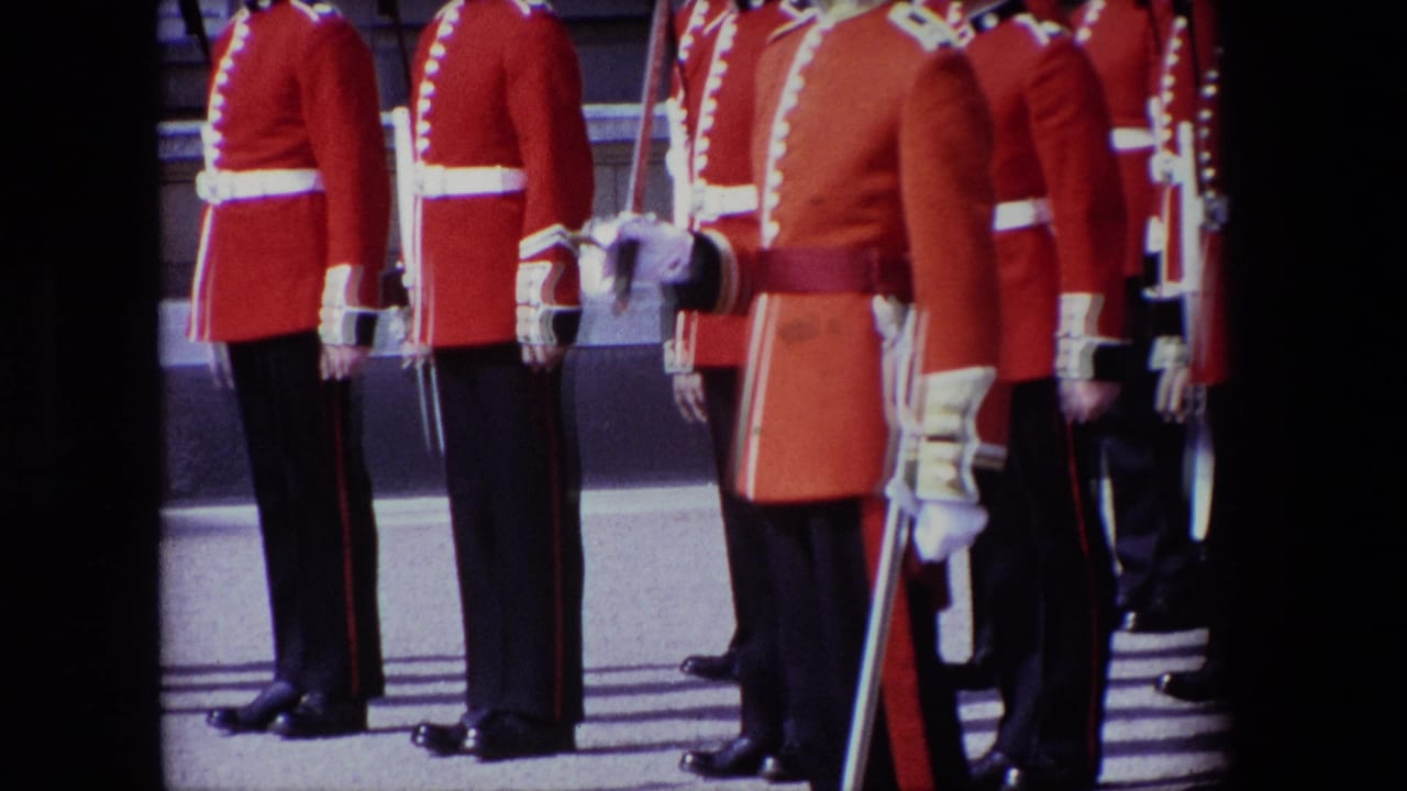 Red-uniformed guards stand in formation with swords and white belts.