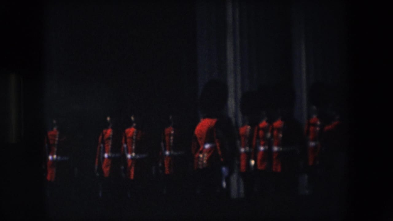 Royal Guard soldiers in red uniforms moving through a dark ceremonial area.