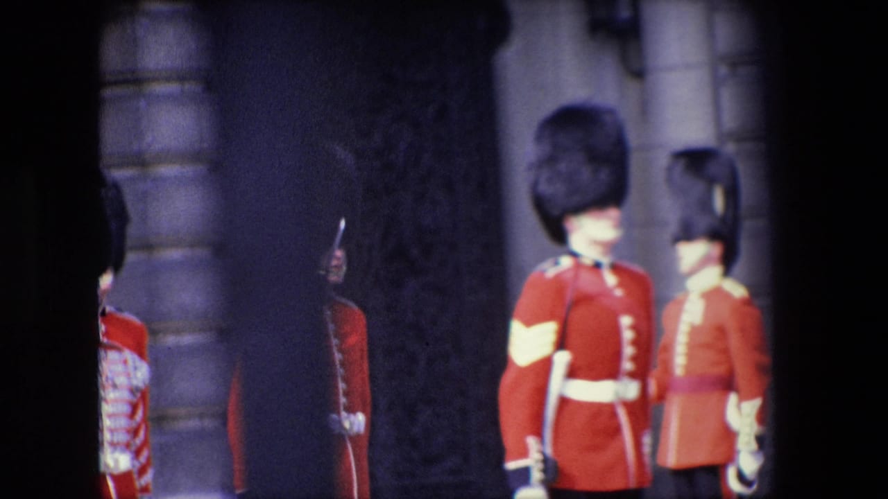 Uniformed red-coated marchers stand or pass near a stone entrance in deep shadow.