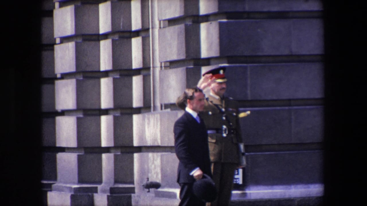 Uniformed officer salutes while a suited man stands nearby holding a hat.