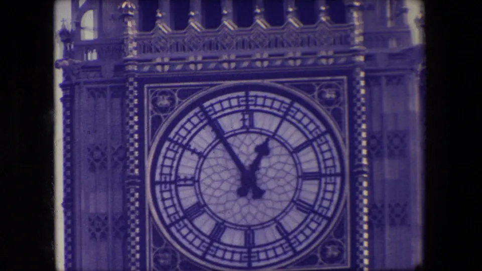 1967 London frame showing a tight view of the Elizabeth Tower clock face and surrounding Gothic Revival detail, bordered by the scanned film frame.
