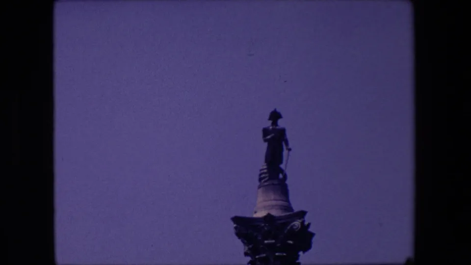 A final 1967 London frame shows the column-top statue and nearby streetlamp under a mostly open sky, with the home-movie scan edges visible.