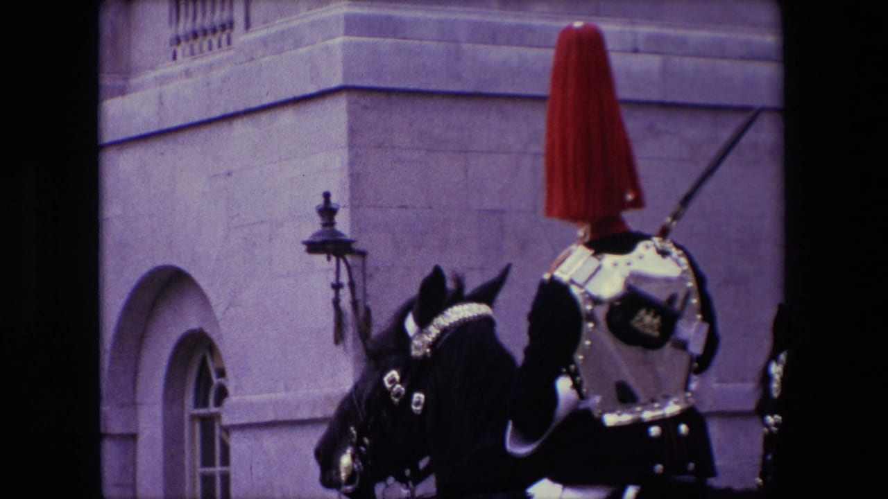 Mounted ceremonial guard and dark horse beside a stone building.