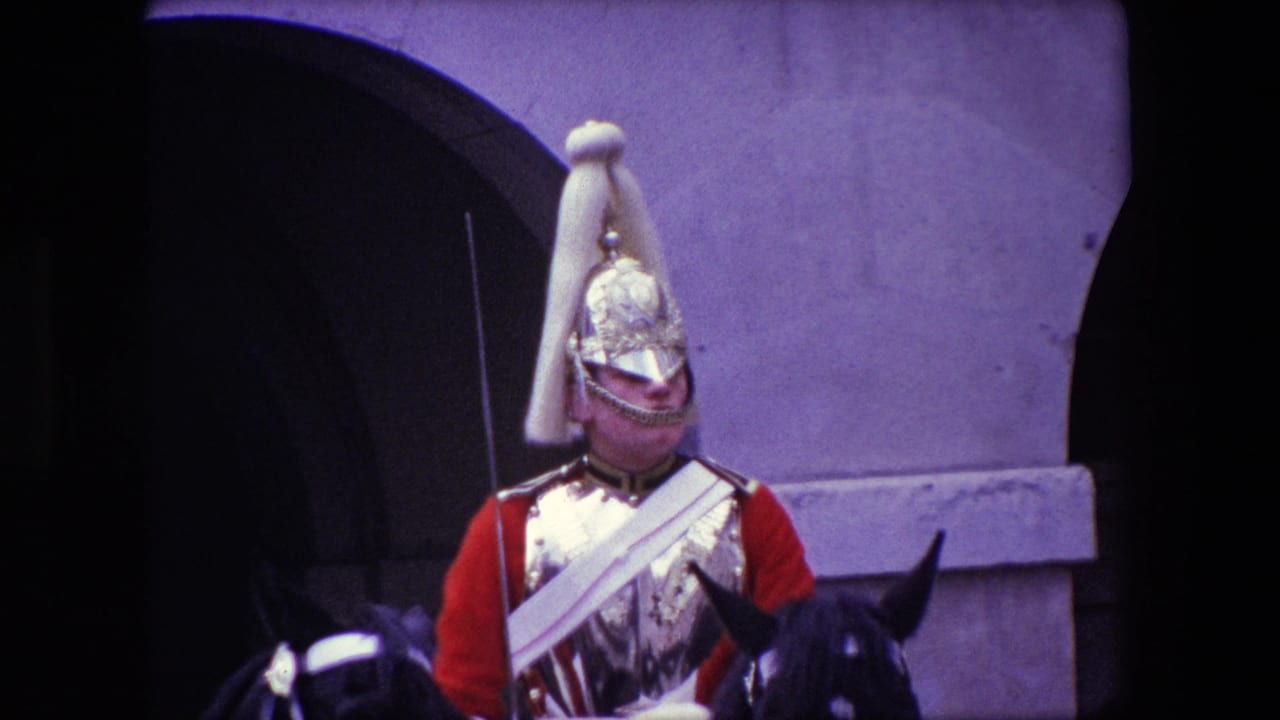 Ceremonial guard on horseback in front of a stone arch and wall.