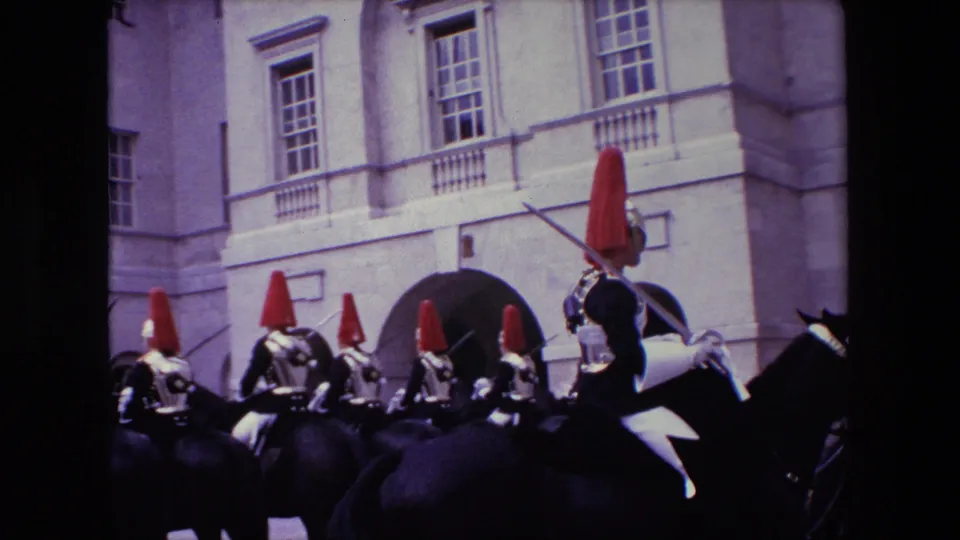 The final frame shows multiple mounted ceremonial soldiers from behind and side view, their red plumes and silver armor standing out against a pale London courtyard facade described by the clip metadata.
