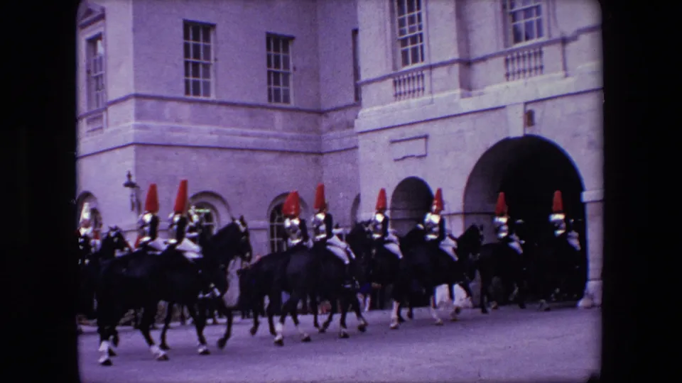 A 1967 London frame shows a ceremonial mounted formation continuing along the street, partly silhouetted against pale stone buildings.