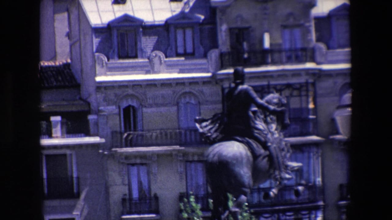Equestrian statue and building facade with a dark foreground obstruction near the center.