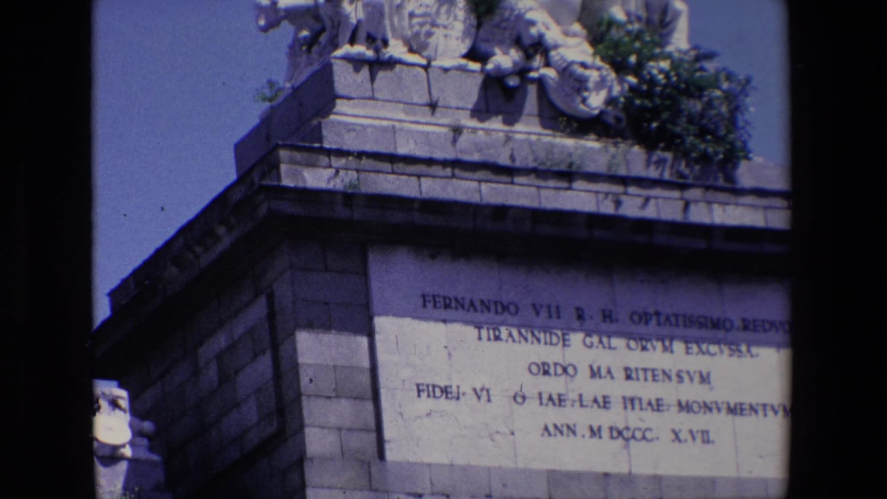 Closer view of monument inscription beneath sculptural stone figures.