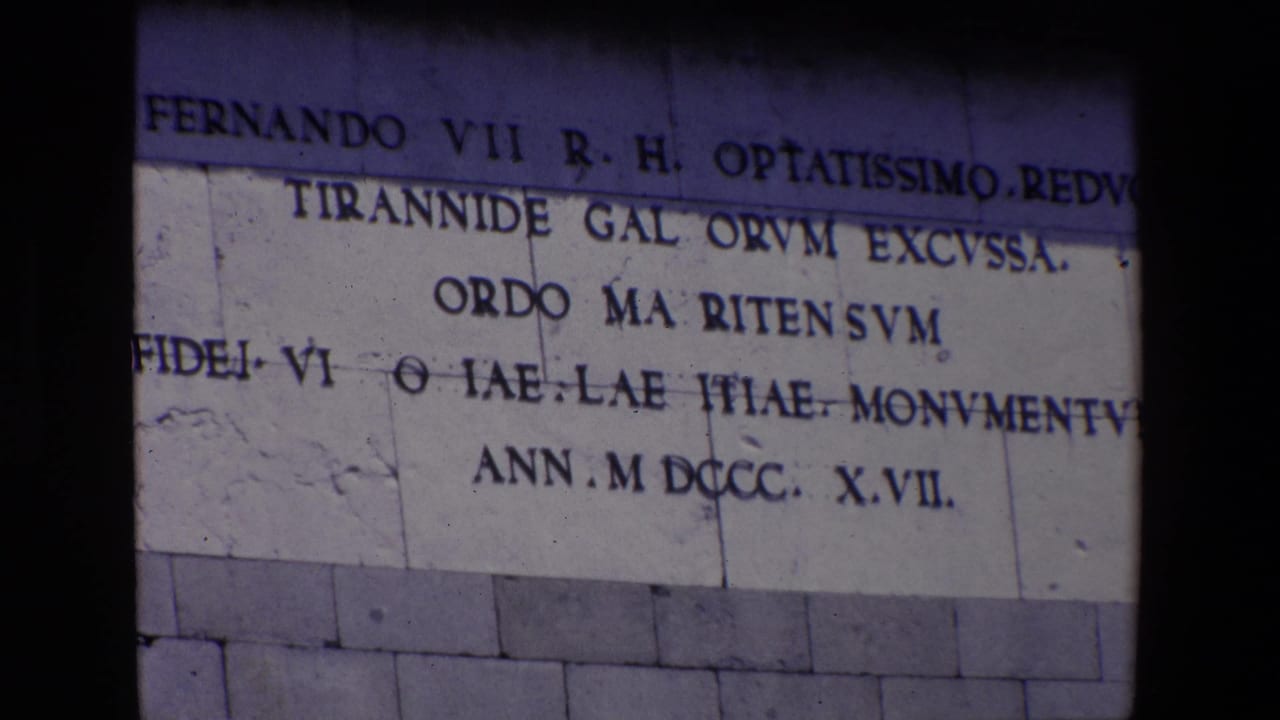 Stone building inscription with Latin-style lettering cropped across the frame.