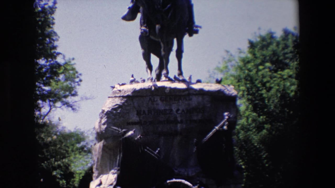 Equestrian statue on a stone pedestal with trees in the background.