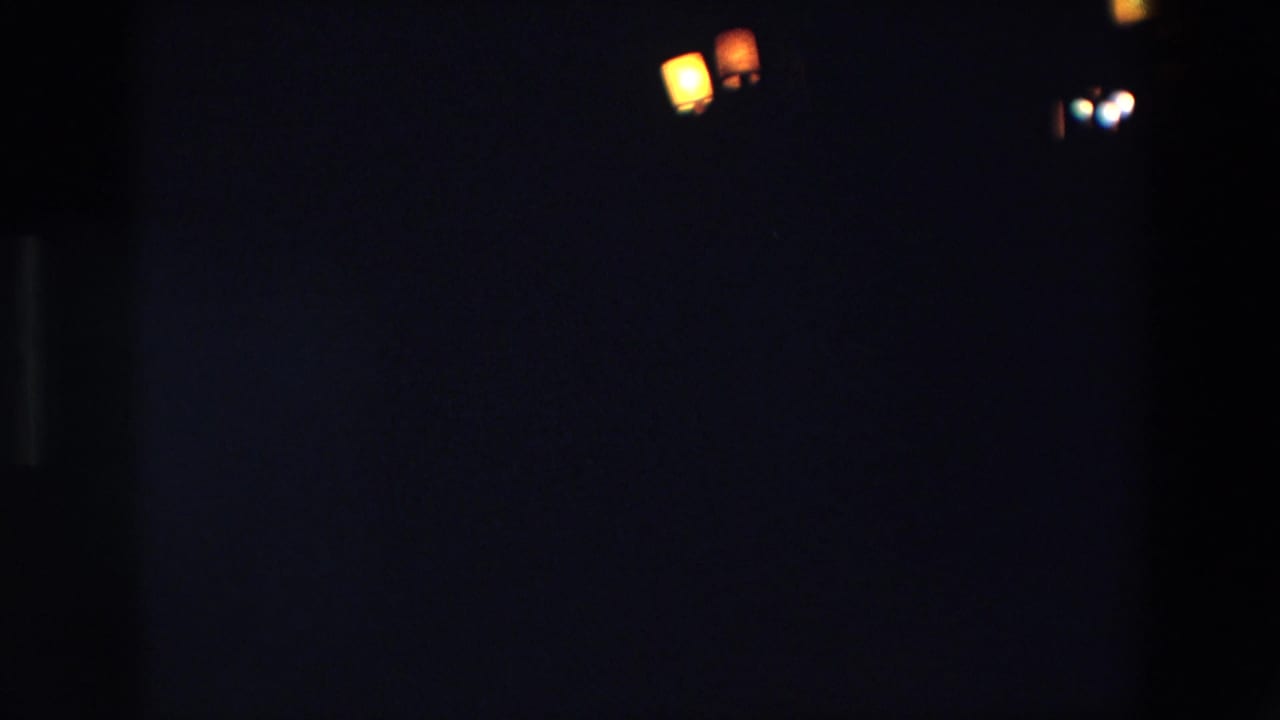 Several small lights appear near the top of a dark frame.
