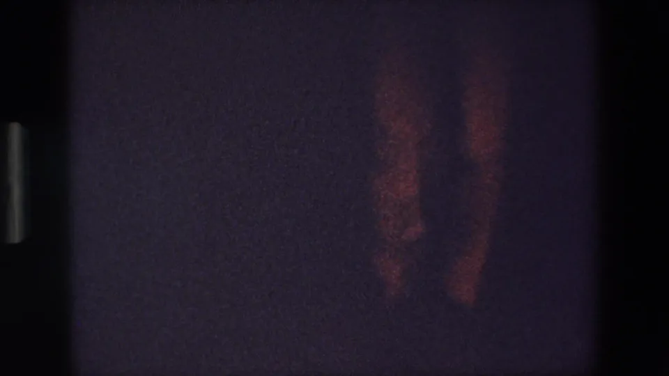 The final frame shows the dancer's legs and shoes partly turned in reddish shadow, with the dark room and 8mm grain obscuring facial or room details.