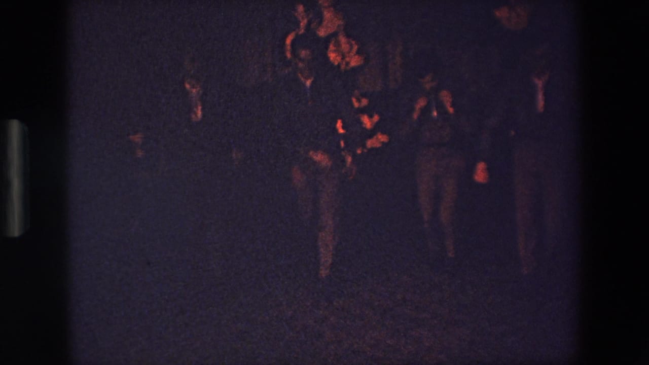 The final frame shows the group still gathered in the shadowed Palermo club scene, with suited figures gesturing or dancing under low red-orange illumination.
