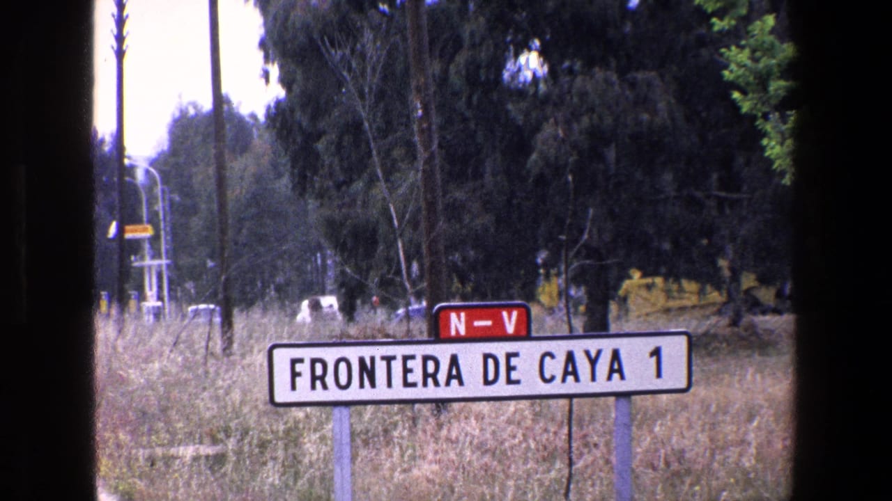 1967 8mm frame, identified by metadata as Palermo, Italy, showing a rectangular roadside sign reading FRONTERA DE CAYA 1 with a red N-V marker above it.