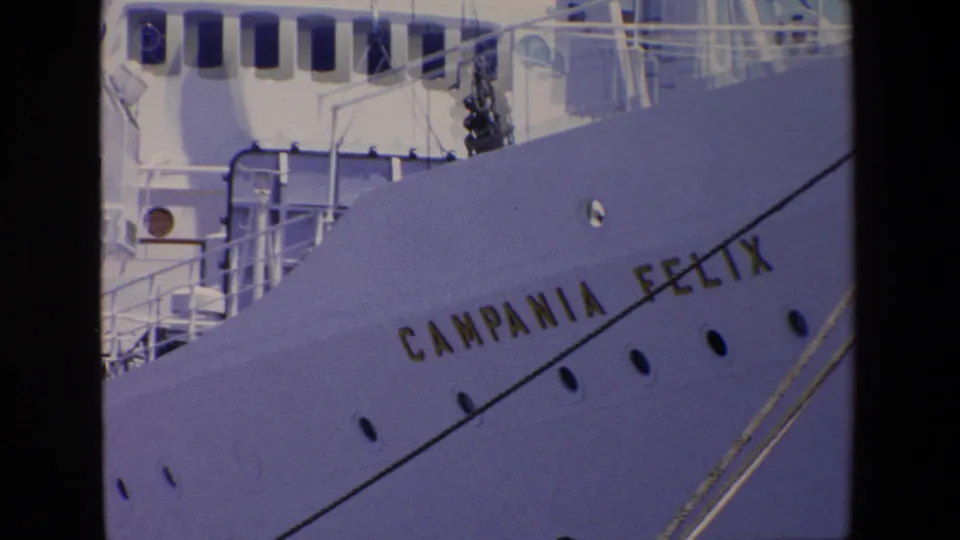 The Campania Felix name appears on the white ship bow, with portholes, railings, and deck fittings visible in the Palermo port footage.