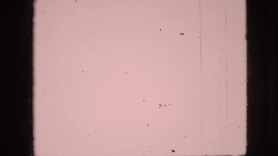 Pale faded 8mm frame from the 1968 Branson, Missouri home movie, with dust, vertical marks, and dark frame edges but minimal visible subject detail.