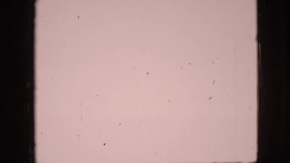 1968 8mm home-movie frame associated with Branson, Missouri, showing a pale sky and faint beach horizon behind heavy film gate edges and dust.
