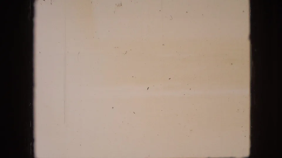 Faded 8mm frame from the stated Branson, Missouri clip, with pale sky, indistinct horizon, and prominent dark vertical frame bars.