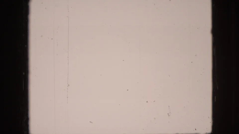 Soft, faded 1968 8mm frame from the Branson, Missouri clip, showing minimal shoreline detail and strong physical film texture.