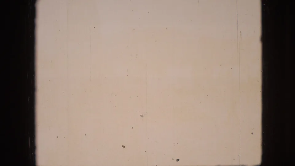 Warm-tinted final frame from the 1968 Branson, Missouri 8mm clip, with faint scene detail, dust, scratches, and uneven aged-film color.
