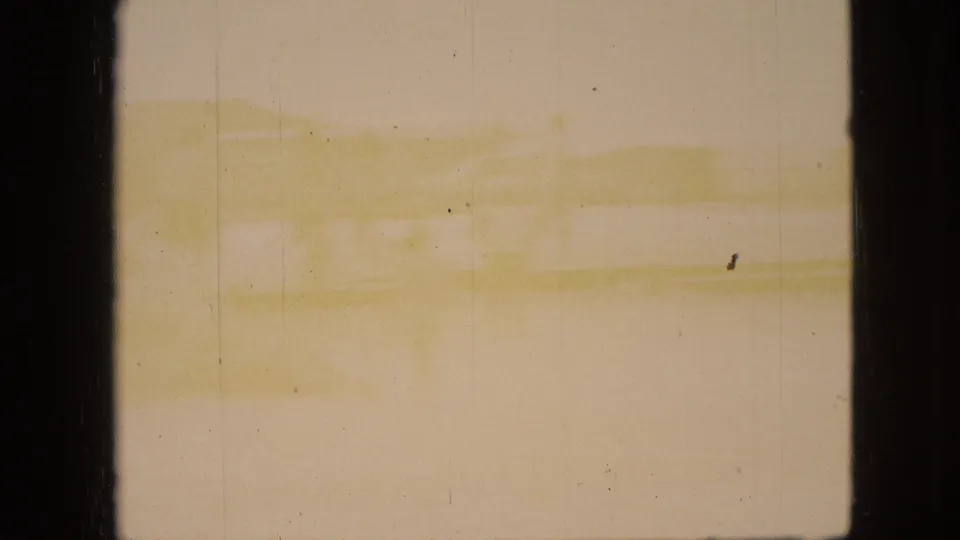 1968 Branson, Missouri home-movie frame showing pale water or shoreline tones through dark vertical borders, with visible grain and aging marks.